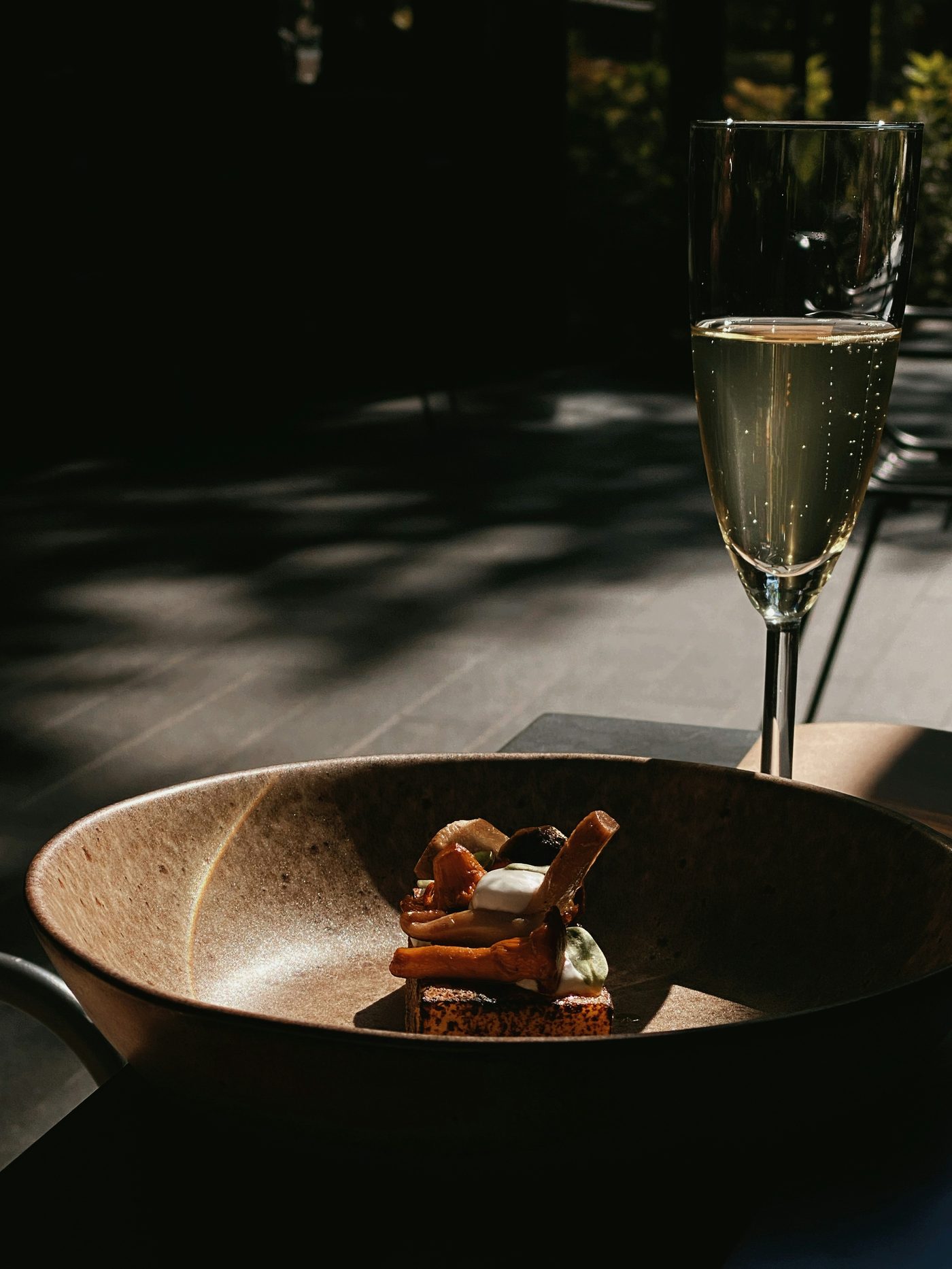 A glass of wine resting on a table in the dining room