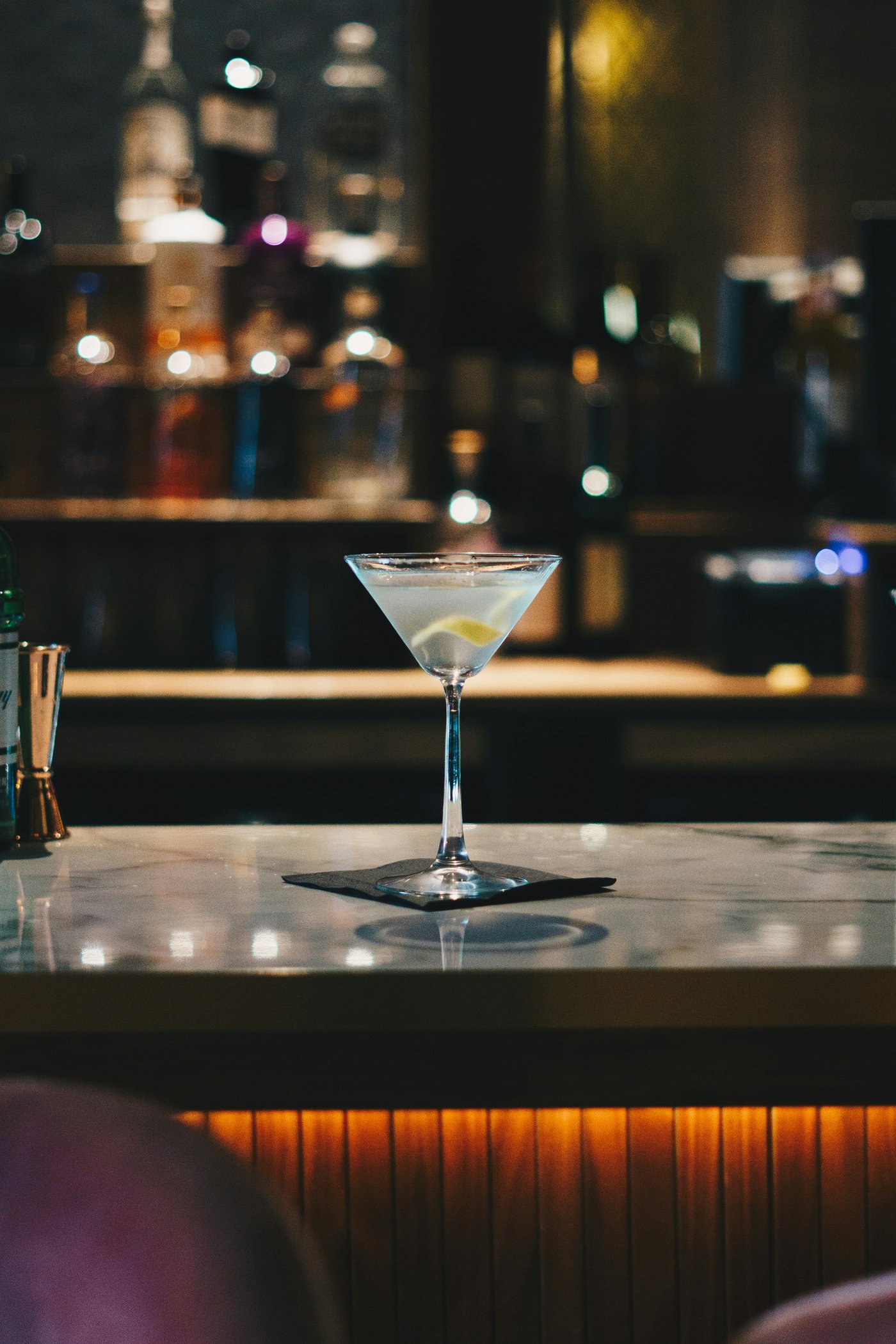 A martini glass on a wooden bar at Noir House